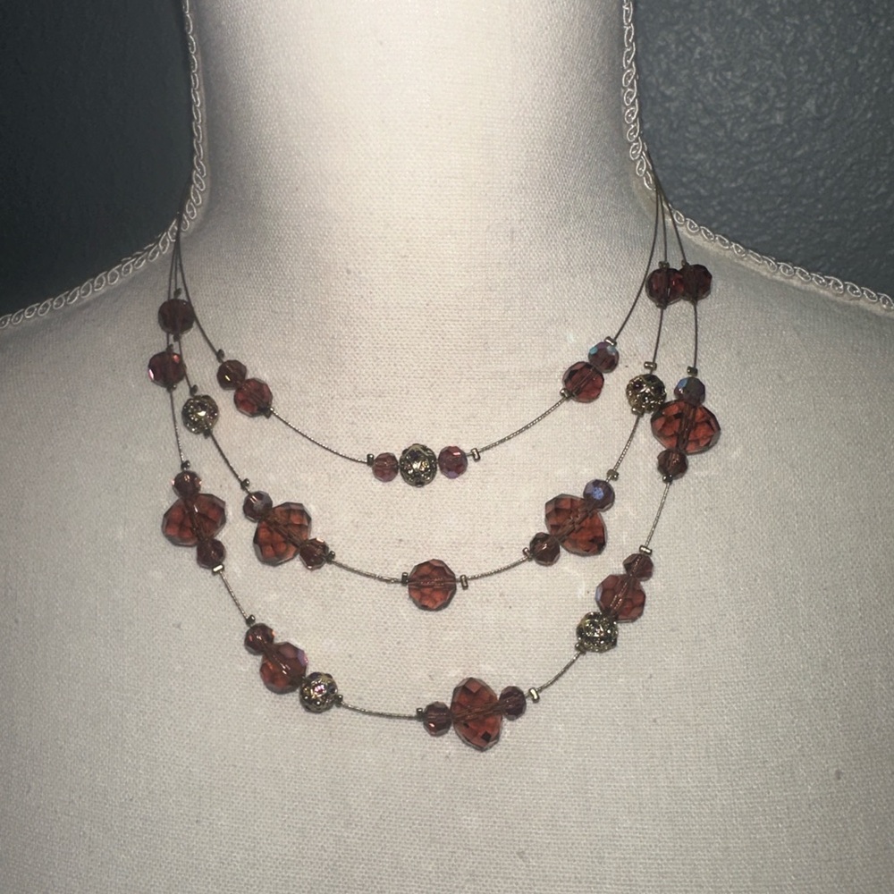 Multi stand beaded necklace with iridescent beads.